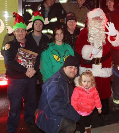 Record crowd enjoys Warwick's Christmas Tree lighting and early Santa visit Santa and his helpers.