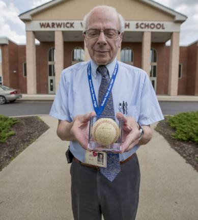 School to display donated memento of 1955 World Series Substitute teacher Yale Ekus holds a baseball signed by the 1955 Brooklyn Dodgers, including players Jackie Robinson and Pee Wee Reese. Ekus has donated the ball to the Athletic Department.