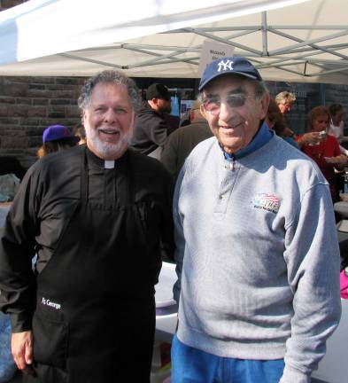 Applefest draws thousands - again Photo by Roger Gavan Father George Kevorkian, pastor of St. Ignatius Antiochian Orthodox Church in the Village of Florida,with Warwick businessman Leo Kaytes, chairman of the St. Ignatius Council. The Church, with its popular food stand, was one of the non-profits that benefit from Applefest.