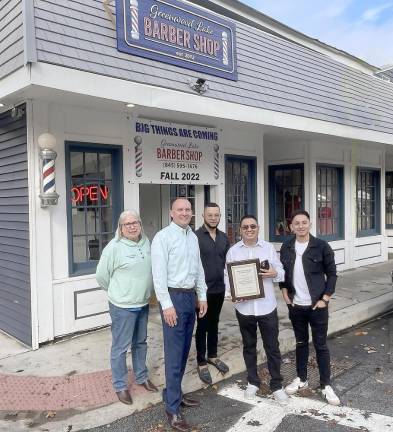 Village Trustee Nancy Clifford, Mayor Jesse Dwyer, barber Leo Taberas, shop owner Iderson Suarez, and barber Erick Suarez