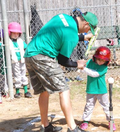 Play ball Coach Joe DiMattina helps this T-Ball batter.
