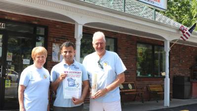Larry's Deli has always been a big supporter. Backpack Snack Attack President Shirley Puett and volunteer Len Singer pose with.Larry's Deli owner Ronak Patel (center).