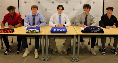 Kojo Adjei, Anthony Numssen, Kayden Zachgo, Carson Rother and Jacob McGowan share the moment during ceremonies last week where they signed their National Letters of Intent to play sports at NCAA colleges and universities. Photo provided by Warwick High School Athletics.