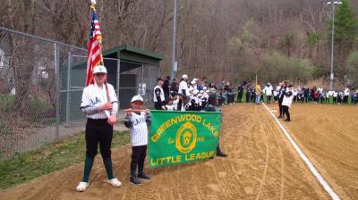 The Greenwood Lake Little League parade was led by the American flag bearer and two players holding the Little League banner.