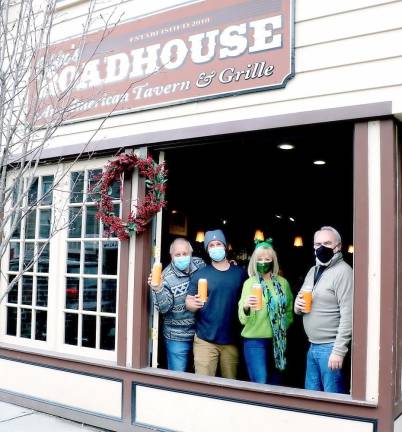 Gathered behind the open-air wall of windows at Eddie’s Roadhouse to formalize plans for the March 23 Warwick Valley Chamber of Commerce “Virtual Beer Tasting” are, from left, Eddie’s Roadhouse owners Ed Cullari and Ed Cullari Jr., Programs Chair Janine Dethmers and Chamber Committee Member and past President John Redman. Photo by Roger Gavan.