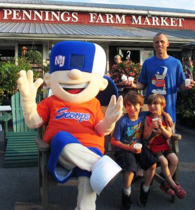 Hip hop artist Timmy Grins serves Apple Ice at Pennings Farm Market On Thursday evening, June 21, Timmy Grins and the ìNew York Scoopsî mascot introduced and served lots of free ìApple Iceî to happy customers like Sebastian Astorino, 8, and his brother Rowan, 4, at Pennings Farm Market.