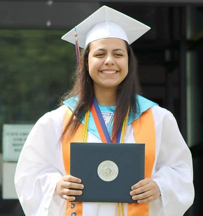 Josely Medina, the Seward Class of 2021 salutatorian, accepts her diploma.