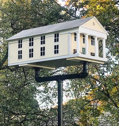 Village resident Andy Capul and former resident John Bradley created a remarkable birdhouse replica of Village Hall that is now on display directly across from Village Hall in Lewis Park.