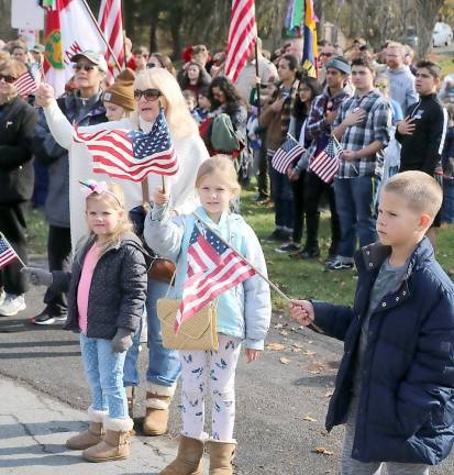 An enthusuastic crowd waved their flags to honor veterans.
