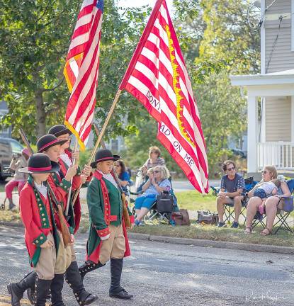 These young men carry an iconic Revolutionary War flag, proclaiming the historic expression of American patriotism: Don’t tread on me..