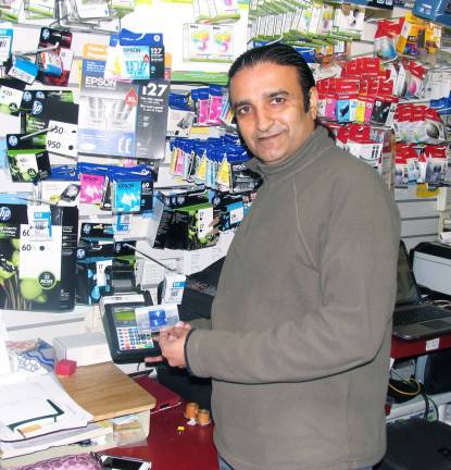Small Business Saturday lures shoppers Photo by Roger Gavan Mohammad Ajmal, owner of The Inkwell, reported business was brisk on Small Business Saturday.