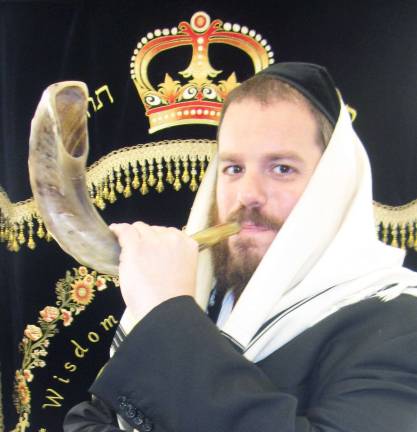 Chabad of Orange County announces High Holiday services and children’s programs Rabbi Pesach Burston, director of Chabad of Orange County, demonstrates the blowing of the Shofar to a group of Hebrew School students. The Shofar (ramís horn) is sounded on both days of Rosh Hashanah. The shofar is the central symbol of Rosh Hashanah, which is celebrated near the beginning of each fall. Synagogues blast the shofar every day for a month leading up to the holiday, culminating with a sequence of 100 blasts during each of Rosh Hashanahís two days - this year on Monday and Tuesday, Sept. 17 and 18. The sound of the shofar is also a reminder of G-dís kingship and a call to repentance.