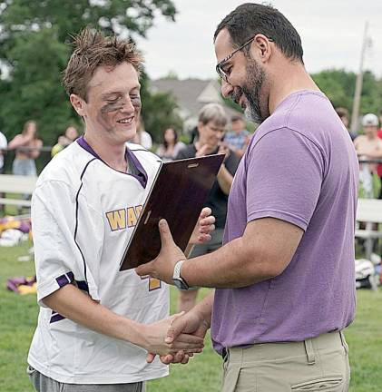 Carlos Barquero of Warwick Athletics presents the Section IX championship plaque to Gavin Zimmerli.