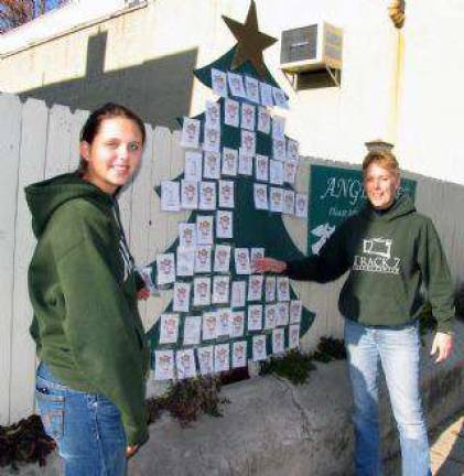 The Angel Tree returns From left, Megan Rota and Betsy Mitchell have finished setting up the 2013 Angel Tree, located between Akin's Drug Store and Newhard's Gift Shop.