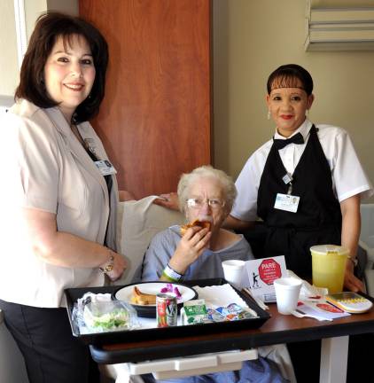 Orange Regional Medical Center offers room service Provided photo From left to right: Director of Nutrition and Food Services Nancy Tienken helps serve a patient with Room Service Associate Yolanda Quioto.