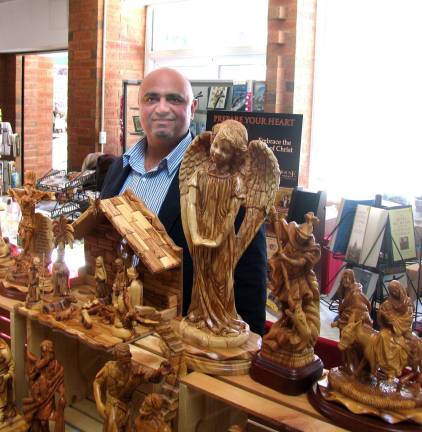 Easter gifts from Bethlehem displayed at St. Stephen's George Dakrat and his family travel to parishes twice a year representing artisans who carve religious figures from the olive tree.