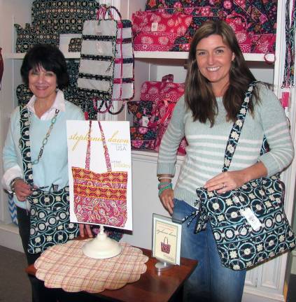 Spring fever event held at Frazzleberries Photo by Roger Gavan From left, Frazzleberries owner Mary Beth Schlichting and her daughter-in-law, Katie, with Stephanie Dawn handbags, the storeþÄôs newest þÄúmade in the USA,þÄù handbag line.