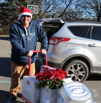 Warwick Ecumenical Food Pantry distributes more than 200 Christmas food baskets Volunteer Mark Alleman.