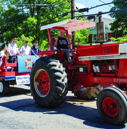 Departed veterans honored Jack Pennings seen on his tractor pulls a float of local veterans.