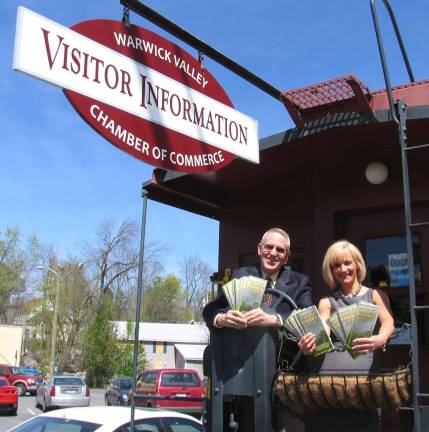 Business community year in review 2012 Photos by Roger Gavan Executive Director Michael Johndrow and Corporate Impressions owner Janine Dethmers display the chamber's new Visitor Guides.