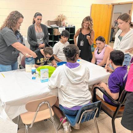 Extended School Year program students explore history, writing and cooking Students learn how to mix and create their own pancakes.
