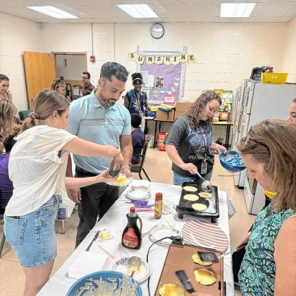Extended School Year program students explore history, writing and cooking Making pancakes as part of the Extended School Year program.