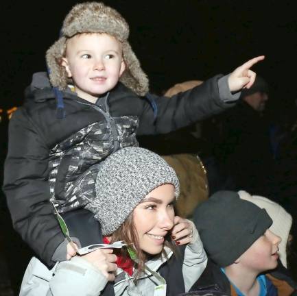 Cruz, 4, has the best seat in the house on the shoulders of his mom, Samantha Eschmann.