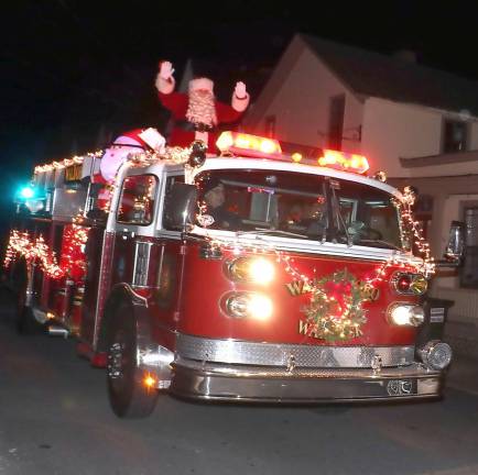 Santa, traveling in a modern fire apparatus, made his usual early surprise visit but it was limited this year to a drive by.