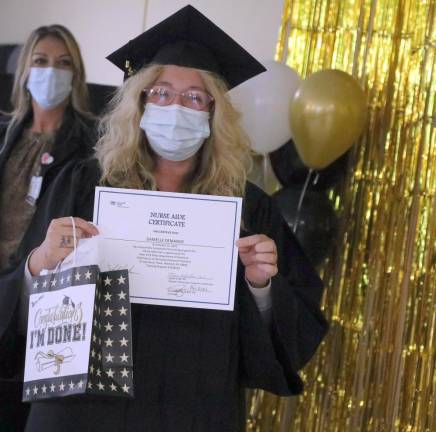 Danielle Demange shows her CNA certificate.