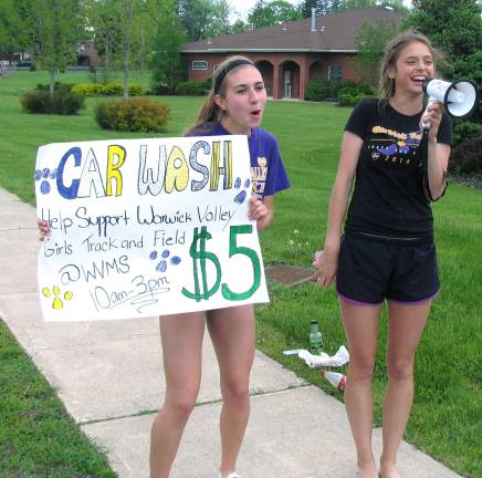 Cross-Country/ Track Booster Club holds car wash From left, Grace Rotar and Lauren Rothstein, both juniors, were among those volunteers.