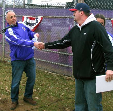 Warwick Little League celebrates opening day for 2014 baseball season During the ceremonies Bart Amatetti, president of Warwick Little League, welcomed everyone and later presented special recognition awards. Pictured here, he presents the Volunteer of the Year Award to Gene Decker.