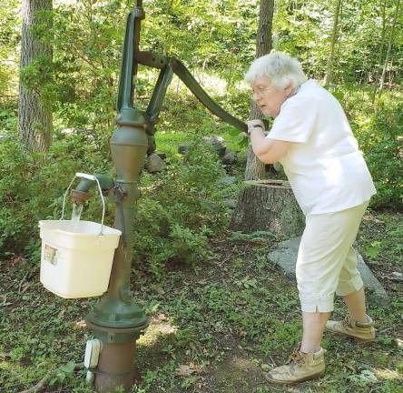 Phyllis Briller, hard at work bringing in another pail of water just like the old days.