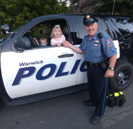 To protect and serve Warwick Police Officer Ed Mullins with Michael and Alexia Balk prior to the fireworks last Saturday at Greenwood Lake.