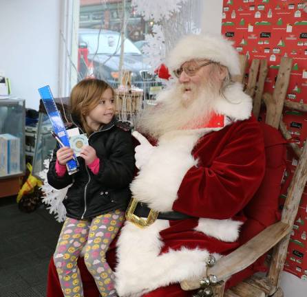 Warwick Sesquicentennial Committee holds Santa event at Akin's Pharmacy Photos by Roger Gavan Santa, aka lifelong Warwick resident Tim Stocken, listened to the last-minute requests from children like Lea Harvey, 6, who asked for a Robot Cat.