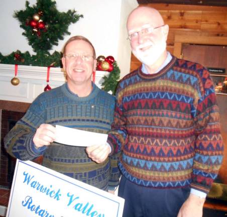 Rotarians continue support for Backpack Snack Attack Photo by Stan Martin Warwick Valley Rotarians continue their support for Backpack Snack Attack with a $500 donation. Club President Neil Sinclair makes the presentation to fellow Rotarian Michael Otte, pastor of the Warwick Reform Church, home of the Backpack Snack Attack program which feeds about 300 elementary students and siblings each weekend.