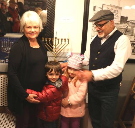 Residents celebrate Hanukkah at 25th anniversary of Warwick Menorah lighting Doris and Moshe Schwartzberg pose with their grandchildren Oscar Carew and Sophia Fotino, both 6.