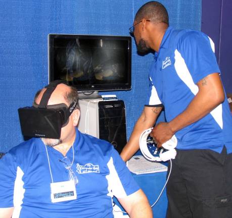 Computer Guy developing Oculus Rift virtual reality programs Photo by Roger Gavan Kevin Brand (seated), owner of þÄúThe Computer Guy,þÄù and computer technician Matt Hibbert demonstrate an Oculus Rift virtual reality program at the recent Warwick Business Expo.