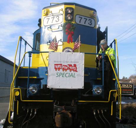 'Operation Toy Train' departs Warwick to deliver toys to needy families Engineer Paul Hintz makes preparations aboard the U.S. Marine Corps ReserveþÄôs Toys for Tots Special Train.