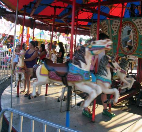 Always the hottest ticket in town Photo by Roger Gavan It seems that the merry-go-round never loses its appeal.