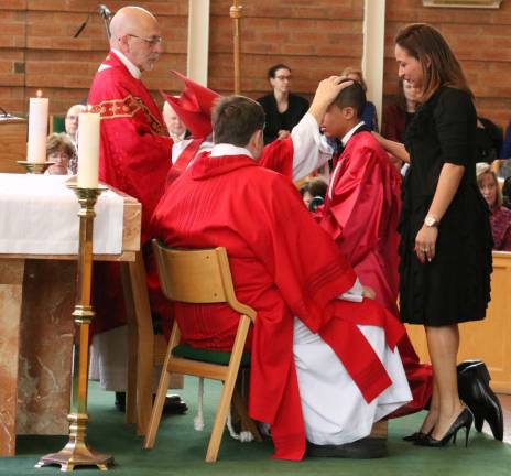 Bishop administers Sacrament of Confirmation at St. Stephen's Each candidate, accompanied by his or her sponsor, came forward to be anointed and confirmed one by one by Bishop Dominick Lagonegro (center) joined by Rev. Jack Arlotta (left), pastor of St. Stephen's, and Deacon John Tomasicchio (right).