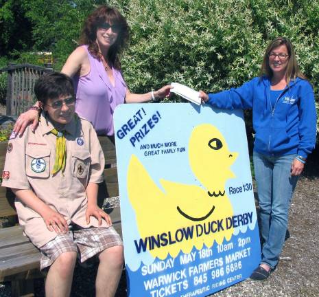Greenwood Lake resident wins $1,000 first place prize in Winslow Duck Derby Sue Ferro (right), executive director of Winslow Therapeutic Center, presents the organizationþÄôs check for $1,000 to Stephanie Harzewski, a resident of Greenwood Lake, accompanied by her son Nicholas, who is a member of Troop 477, an organization that participated in the sale of Duck Derby tickets.