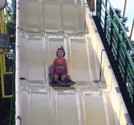 Warwick Firefighters host annual summer carnival Cara Calone, 6, enjoys a ride on the high slide.