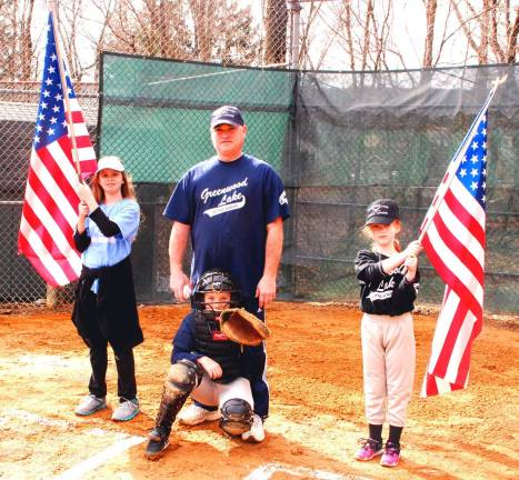 Play ball Chris Cassf, center, and his son Christian, the catcher, with flag bearers Nicole Devalve, left, and Caroline Rourke.