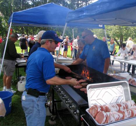 St. Stephen’s parish picnic held Sept. 8 Members of the Knights of Columbus prepare the traditional picnic fare of hamburgers and hot dogs.