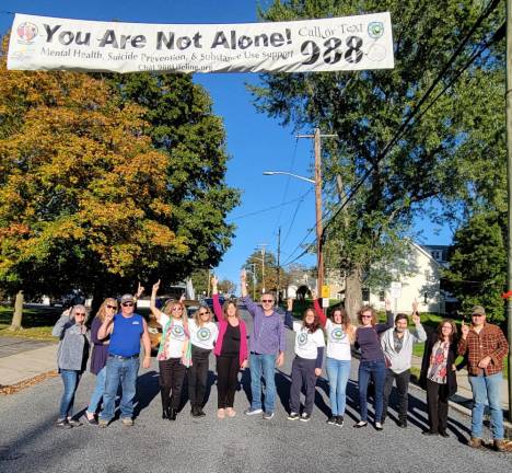 Members of Warwick Cares, Team Up For Hope, Warwick Valley Prevention Coalition and We the People Warwick pose beneath their banner in Florida along with Florida Mayor Daniel Harter Jr.