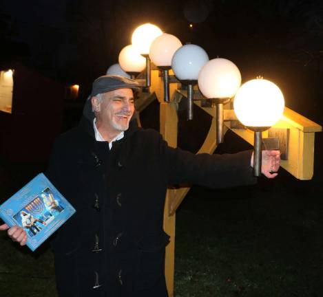 Residents celebrate Hanukkah at 25th anniversary of Warwick Menorah lighting Moshe Schwartzberg lights the first candle.