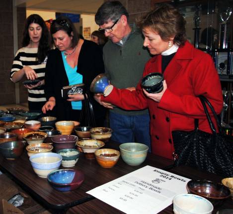 Empty Bowls project raises $35,000 Community members look over the hundreds of bowls of various shapes and colors, made and donated to Empty Bowls by local potters.