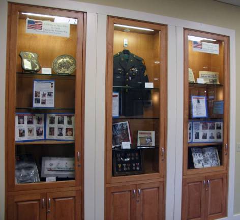 Library honors Vietnam-era veterans Photo by Roger Gavan The Albert Wisner Public Library on McFarland Drive in the Village of Warwick now has a display case in the lower level honoring local veterans of the Vietnam War era.