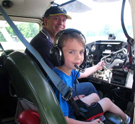 Young Eagles take to the skies at Warwick Municipal Airport Photo by Roger Gavan Finbar O'Connor, 6, gets ready to take his first Young Eagle's flight in the co-pilot's seat of a Cessna 172 with owner Brian Adkins. Finbar's feet, however, may not reach the rudder pedals.