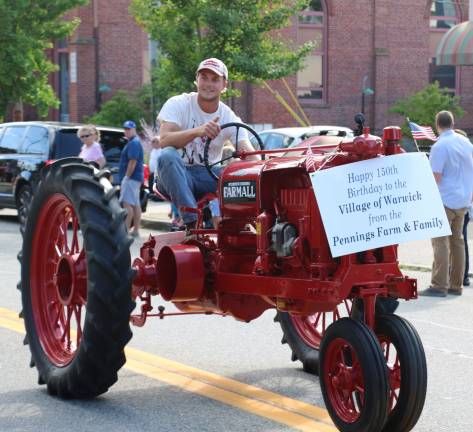 Village of Warwick celebrates 150 years A vintage tractor courtesy of Pennings Farm drives down the parade route.